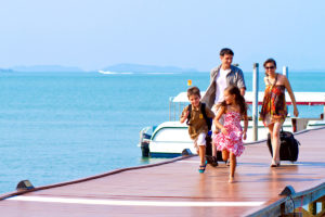 A family of four walking at the boardwalk