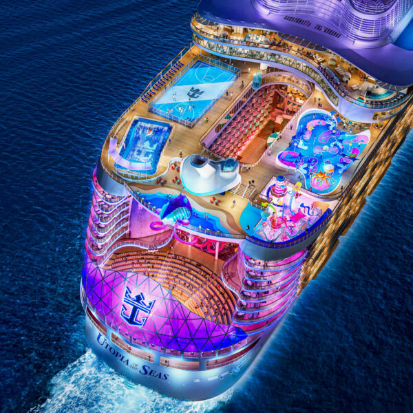 An aerial shot of a cruise ship lit up at night