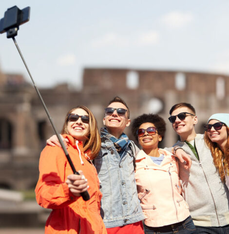 A group taking a picture at the Coliseum Ruins in Rome